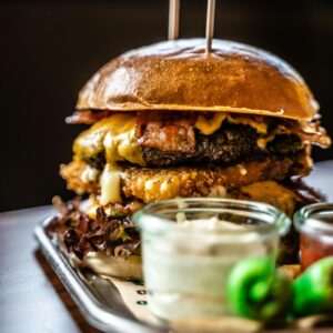 Delicious gourmet cheeseburger paired with fries and dips, perfect for food lovers.